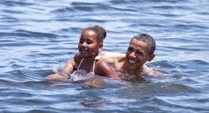 President Obama and his daughter Sasha swim in cove behind their hotel in Panama City Beach, Florida. 